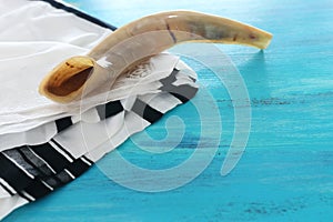 Religion image of shofar horn on white prayer talit. Rosh hashanah jewish New Year holiday, Shabbat and Yom kippur concept