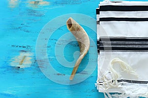 Religion image of shofar horn on white prayer talit. Rosh hashanah jewish New Year holiday, Shabbat and Yom kippur concept