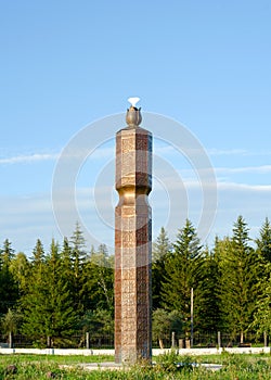 Religion of the Northern peoples of Yakutia - Serge with symbols and a flower at the top at the entrance to the Park