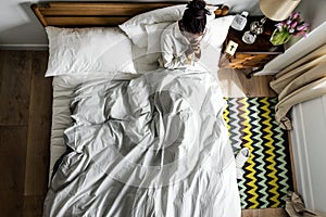 Religious African American woman on bed praying