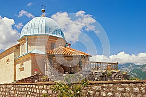 Religious architecture. Ancient Church of Our Lady of the Rocks on sunny summer day. Montenegro