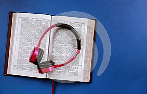 Religious audiobook with Bible and headphones