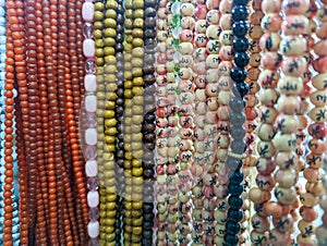 Religious beads with colorful strings. Muslim prayer chaplet market close up shot. Colorful plastic rosaries in the market.