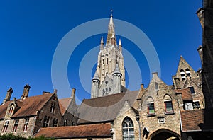 Religious buildings with the tower of the gothic cathedral of the city of Bruges. photo