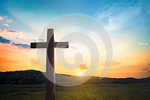 Religious concept: Jesus Christ wooden cross with dramatic lighting background