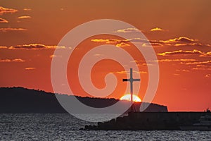 Religious cross and rising sun behind it. Resurrection of the lord, easter, nativity of Jesus Christ. Nessebar, Bulgaria