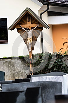 Religious cross with sculpture on a cemetery