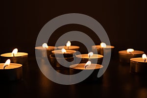 Religious and devoutness scene: candles burning in the dark