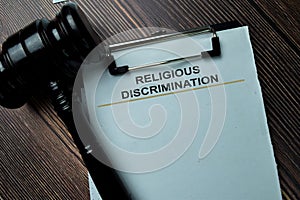 Religious Discrimination Document form and Black Judges gavel on office desk. Law concept