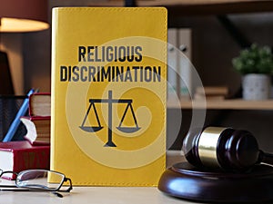 Religious Discrimination is shown using the text on the book and photo of court gavel