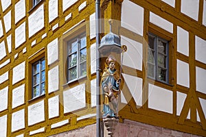 Religious figure carved on one of the 22 medieval half-timbered old houses in Weissgerbergasse, Nuremberg, Germany