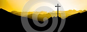 Religious grief landscape background banner panorama - View with black silhouette of mountains, hills, forest and cross / summit photo