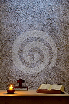 Religious image, interior of a church, close-up of an altar with overhead lighting and candles