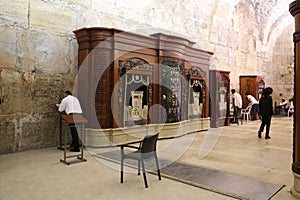 Religious Jews pray by the Western Wall inside of the Western Wall Tunnel at the Old City of Jerusalem.