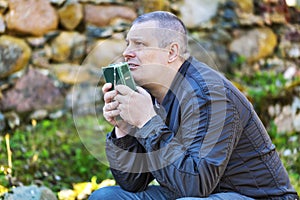 Religious man with Holy Bible and Rosary at Place of Worship