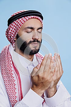 Religious muslim man praying to god
