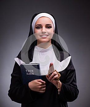 Religious nun in religion concept against dark background