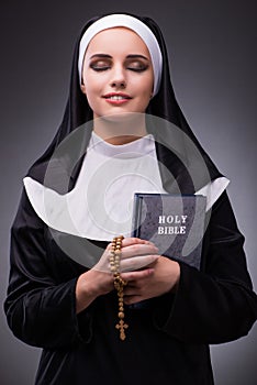 The religious nun in religion concept against dark background