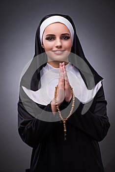 The religious nun in religion concept against dark background