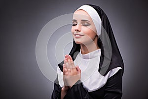 The religious nun in religion concept against dark background
