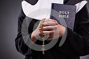 The religious nun in religion concept against dark background