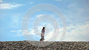 Religious outcast walking in desert, lonely tired man fasting seeking God