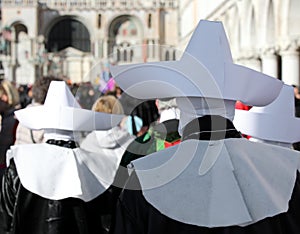 religious procession with nuns wearing tunics and large white hats