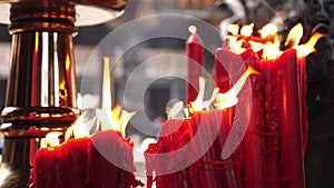 Religious red candle fire burning dancing in the wind in Longshan Temple, Taiwan Taipei