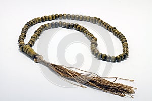 Religious rosary on white ground