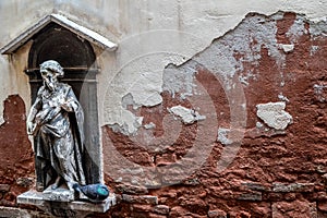 A religious sculpture on a street in Venice
