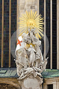 Religious statue with golden rays and angels in front of St. Stephen Cathedral in Vienna