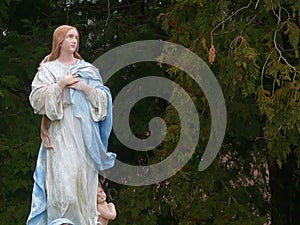 Religious Statue Iconography Mary in an Outdoor Setting with an Angel at her feet