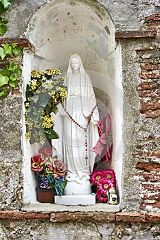 Religious Statue of Mary with Offerings of Worshipers in Form of