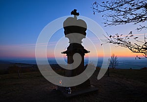 Religious stone monument at a top of a hill