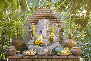 Religious stone sculpture of Ganesha god in garden, Thailand.