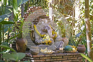 Religious stone sculpture of Ganesha god in garden, Thailand.