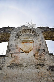 Religious symbol. Ruins of an ancient synagogue with arched windows, against the blue sky. Texture old dilapidated masonry