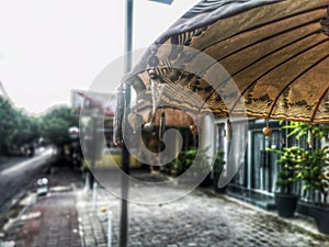 Religious symbolic umbrella on a street of an Indonesian city on a rainy day