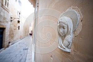 Religious Virgin Mary figure on a house wall