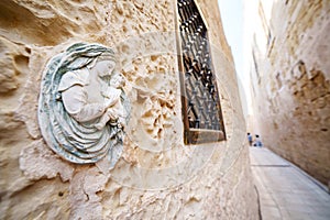 Religious Virgin Mary figure on a house wall