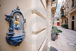 Religious Virgin Mary figure on a house wall