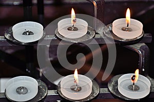 Religous candles on inside of cathedral photo