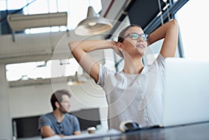 Relish in the success youve earned. a young woman working on a laptop in an office.