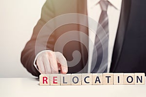 Relocation concept. Man pointing at relocation inscription