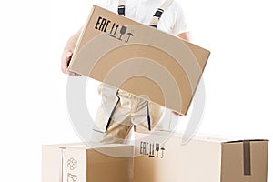 Relocation service man holds cardboard box in hand closeup isolated on white background. Loader worker with box.