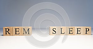 Rem sleep text from wooden cubes. Photo was taken in white background