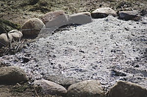 Remaining of bonfire enclosed by stones.