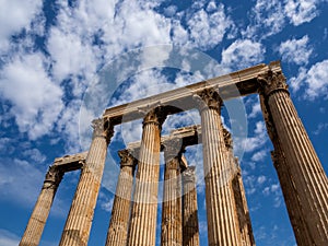 Remaining columns of Temple of Olympian Zeus in Athens, Greece shot against blue sky and picturesque clouds