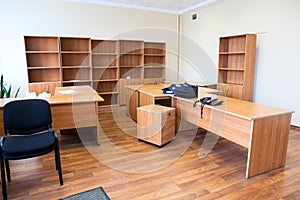 Remaining furniture as tables and cabinets in empty office after the tenant`s eviction photo