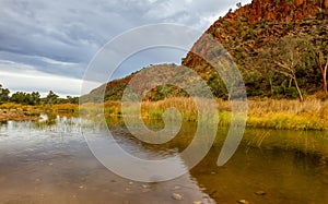 Clouds over the red quartzite cliffs at Glen Helen Gorge